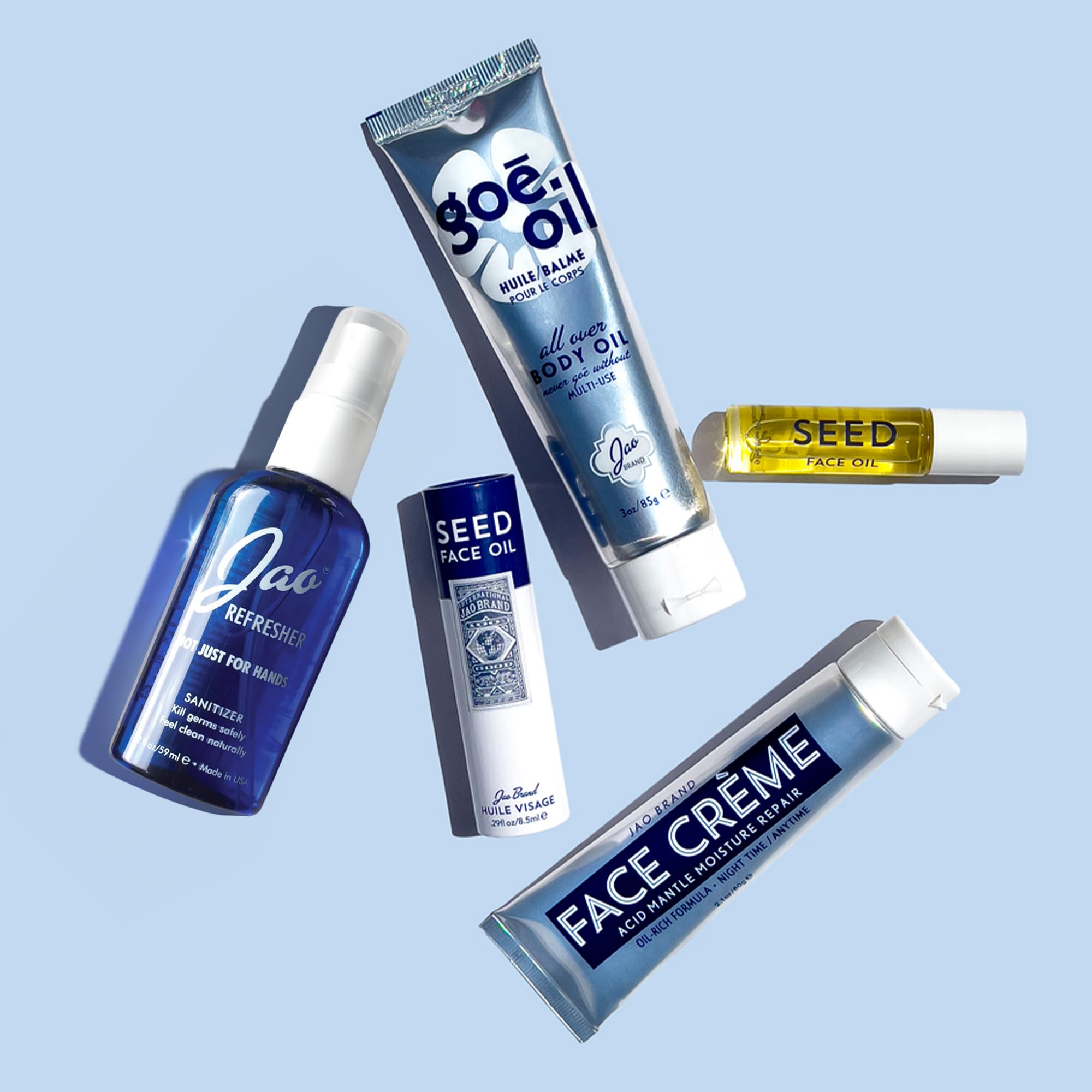 Jao Refresher travel-size 4 oz bottle beside passport and skincare items.