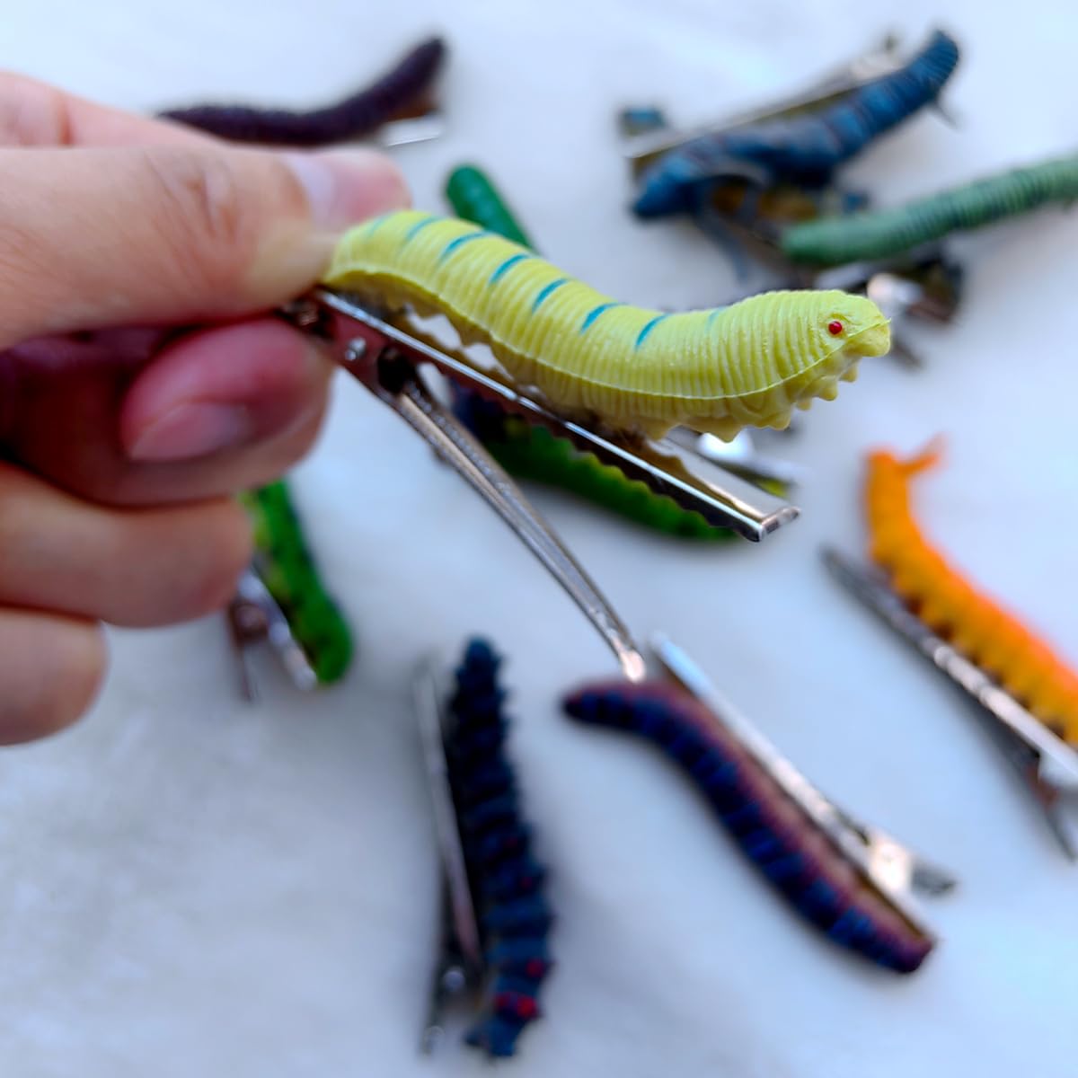 JINBUYAO caterpillar hair clip blue creates eye-catching accessory.