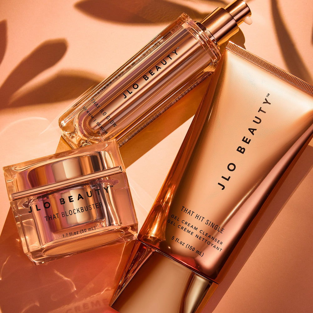 JLO Beauty That JLO Glow Serum vial against soft background highlighting tri-fermented formula.