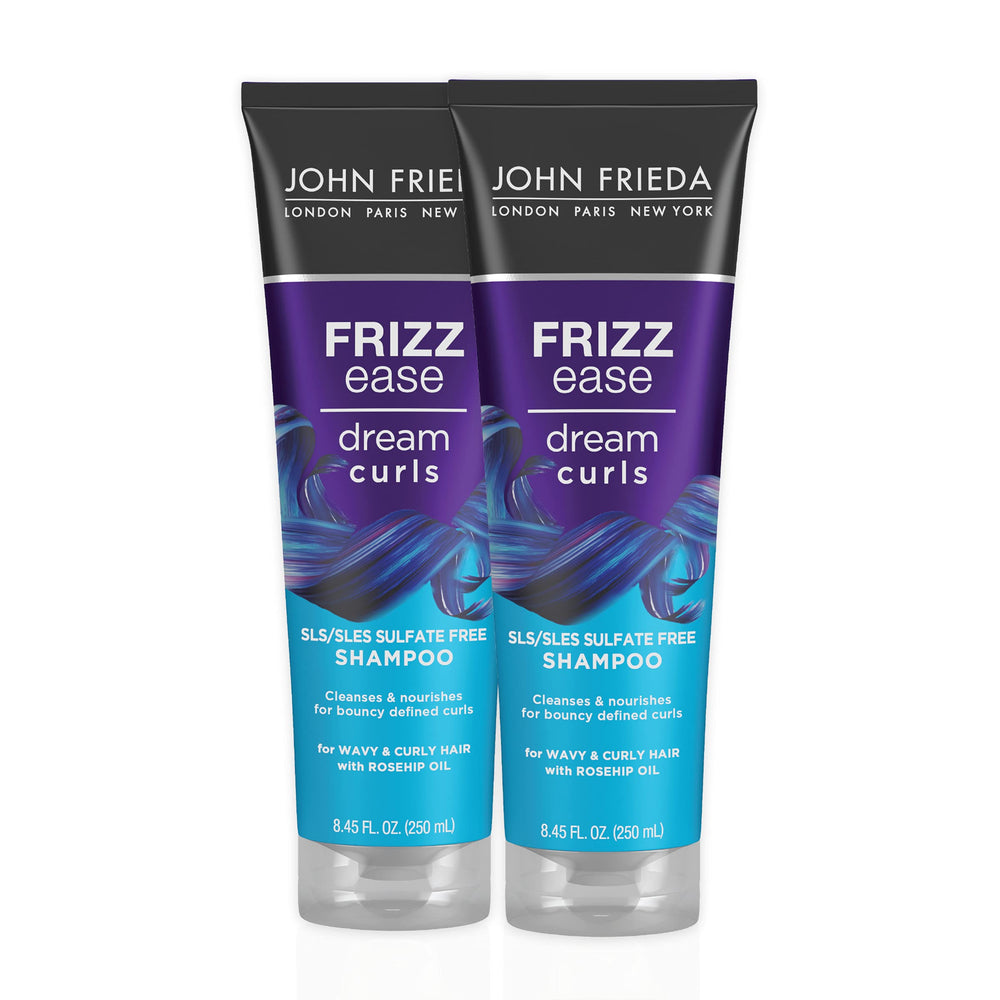 John Frieda Dream Curls Shampoo bottle on sink for defined, frizz-free curls.