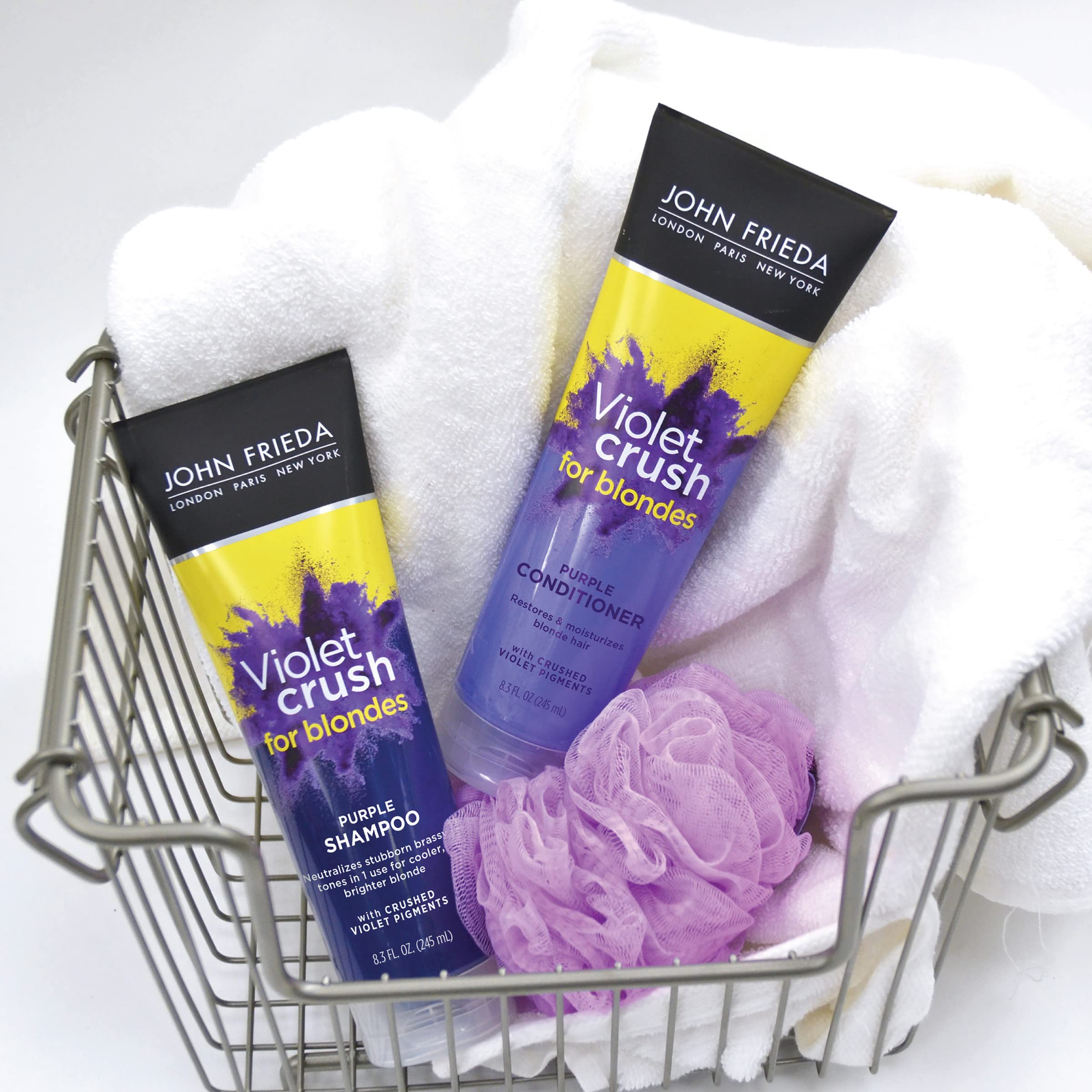 John Frieda Violet Crush shampoo lathering on hair showing violet pigments at work.