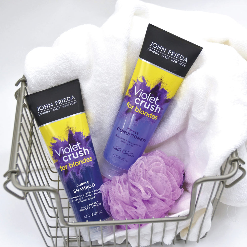 John Frieda Violet Crush shampoo lathering on hair showing violet pigments at work.