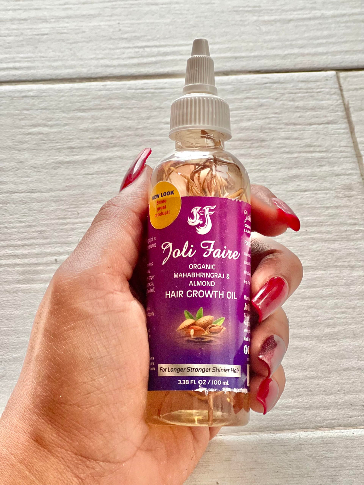 Joli Faire Hair Growth Oil bottle pour for easy daily scalp nourishment.
