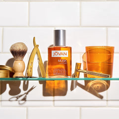 Jovan Musk for Men packaging emphasizes sleek glass bottle with orange hue.