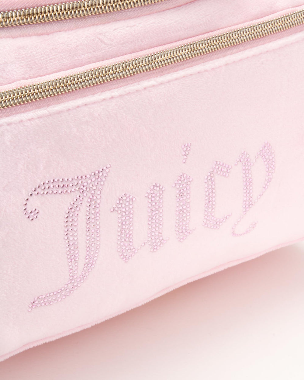 Juicy Couture pink makeup bag hanging strap demonstrates easy access during travel routines.