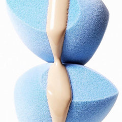 JUNO & Co. sponge shown applying foundation with a seamless wet-application motion.