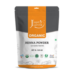Just Jaivik Henna Powder packaging shows 100% natural organic certification for hair color.
