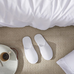 Juvale spa slippers in a hotel room ready for guest comfort