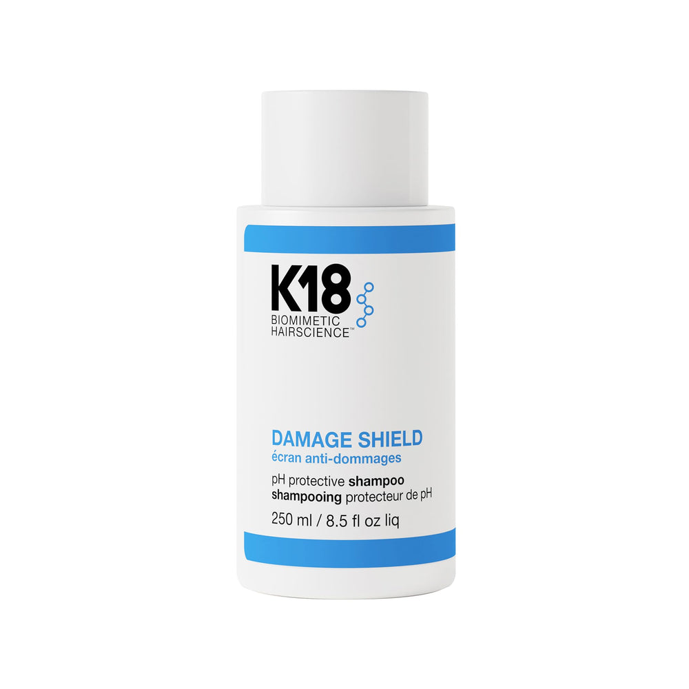 K18 Damage Shield Shampoo bottle demonstrating color-safe cleansing for vibrant, healthy hair.