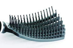 KareCo Tangle Buster Brush featuring a long durable rubber handle for comfortable grooming.