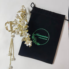 KEMMINTVN pearl tassel bun holder adds dangling pearls for a romantic bun.