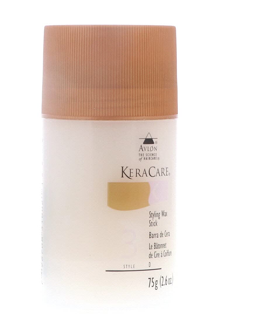 KeraCare Styling Wax Stick packaging sits beside grooming tools for travel-ready use.