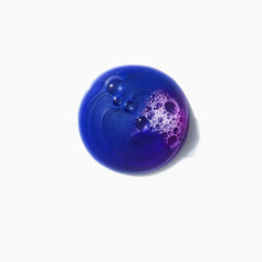 KÉRASTASE Blond Absolu shampoo lather reveals purple tint for brass neutralization.