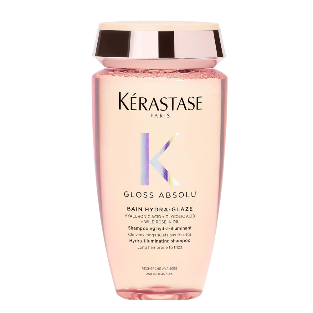 Kerastase Gloss Absolu shampoo bottle pouring for a smooth, glossy cleanse.