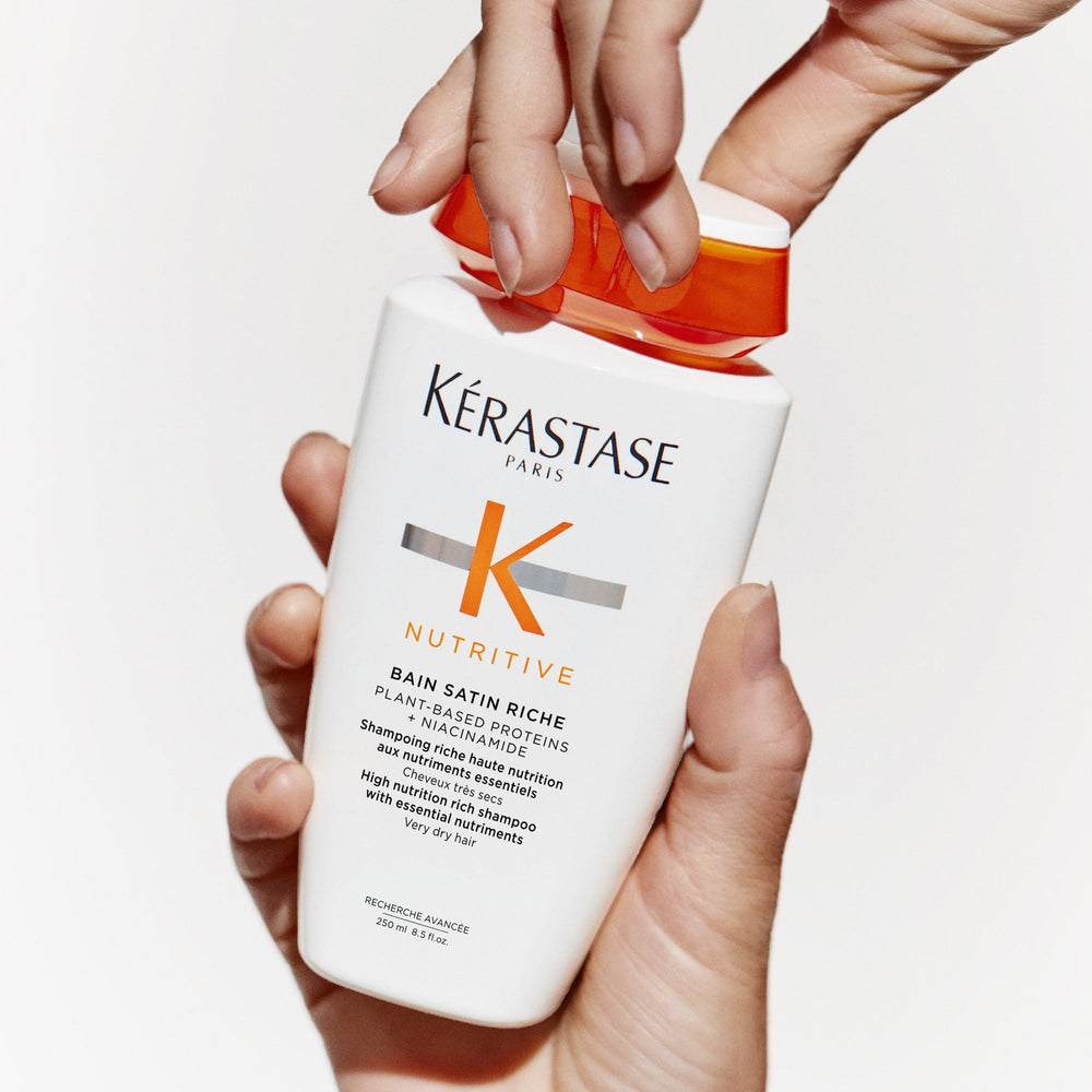 KÉRASTASE Nutritive Bain Satin Riche bottle with plant-based proteins nourishes strands.