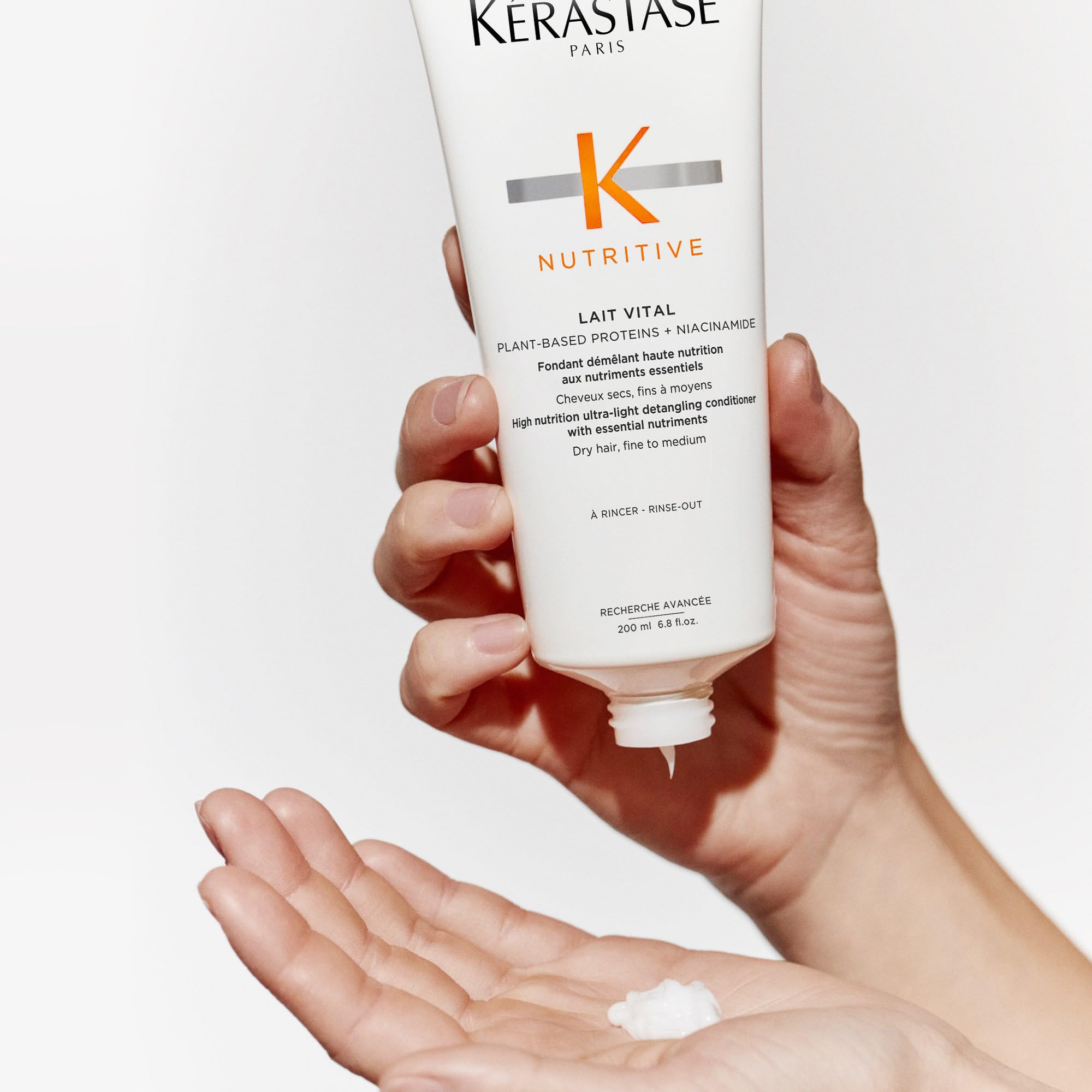 Kerastase Nutritive Lait Vital conditioner dispenser illustrates easy detangling application.