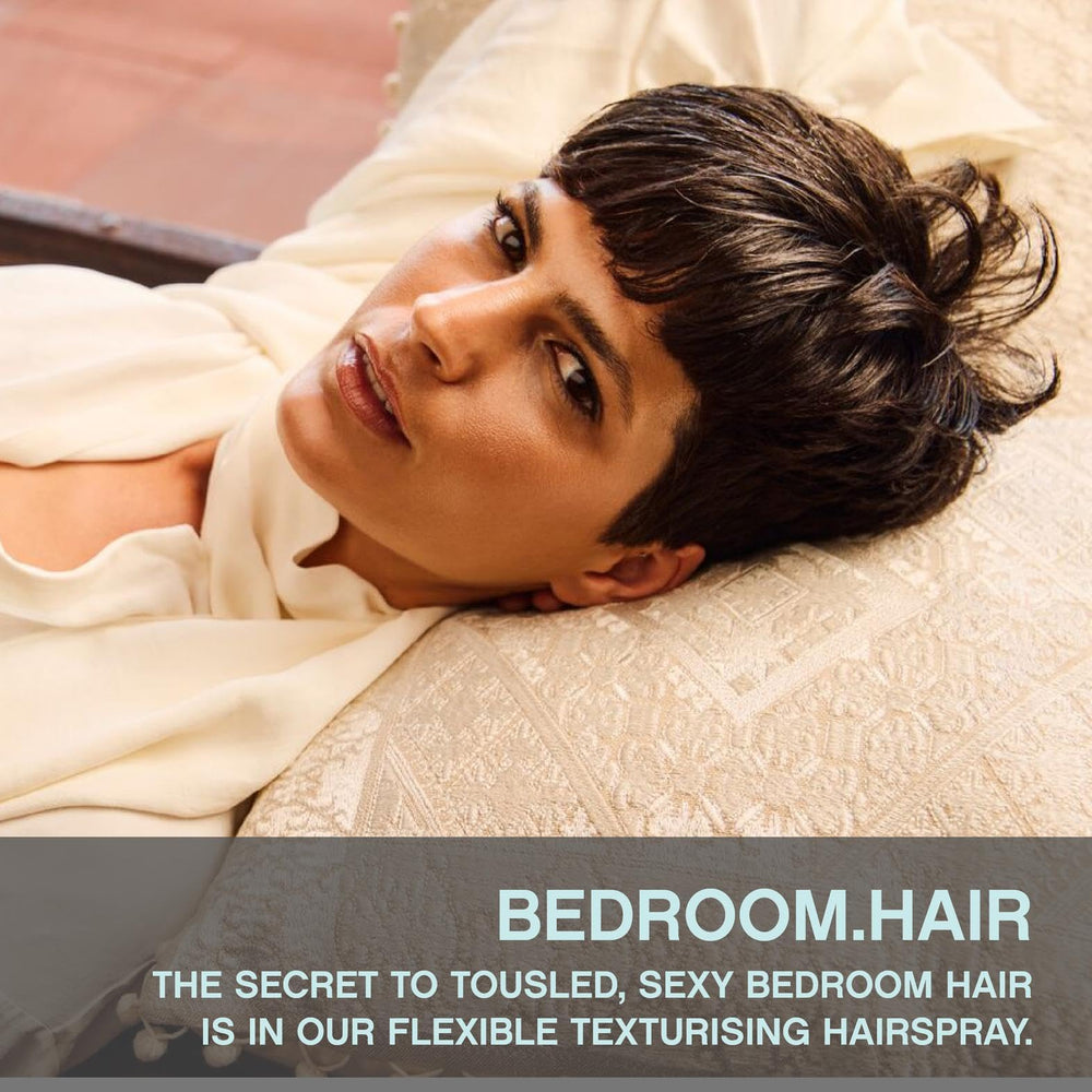 KEVIN.MURPHY BEDROOM.HAIR texture spray closeup shows light hold and touchable finish.