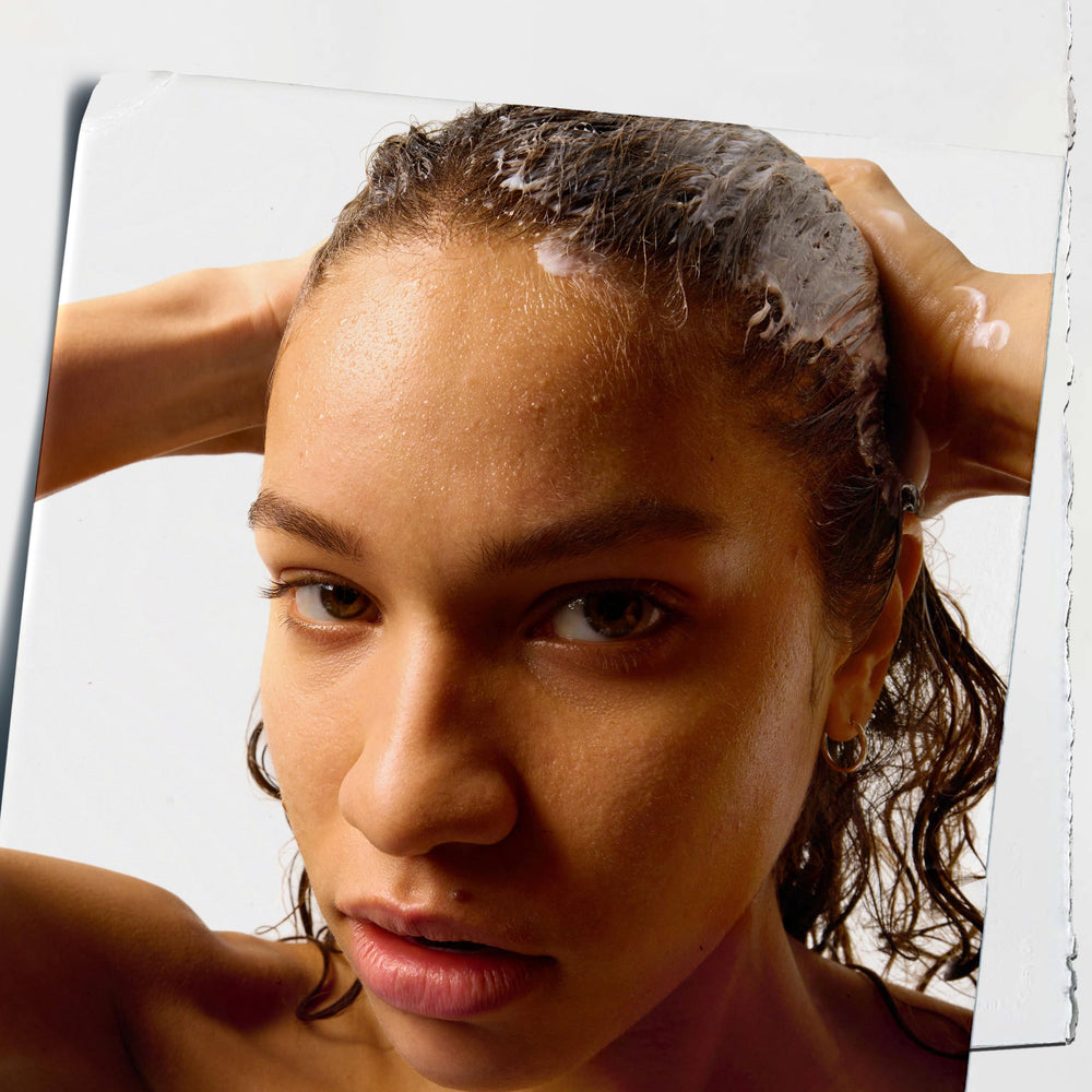 Kiehl's Amino Acid Conditioner applied to wet hair for two-minute nourishment.