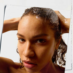 Kiehl's Amino Acid Conditioner applied to wet hair for two-minute nourishment.