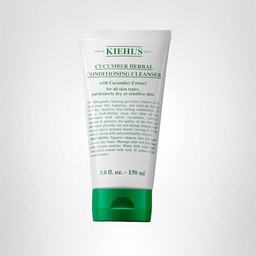 Hands applying Kiehl's cleanser to damp face for easy massage