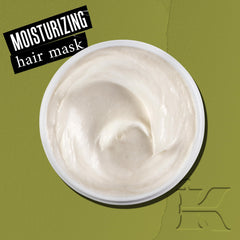 Kiehl's Olive Fruit Oil Deeply Reparative Hair Mask tub closeup shows creamy formula for even distribution.