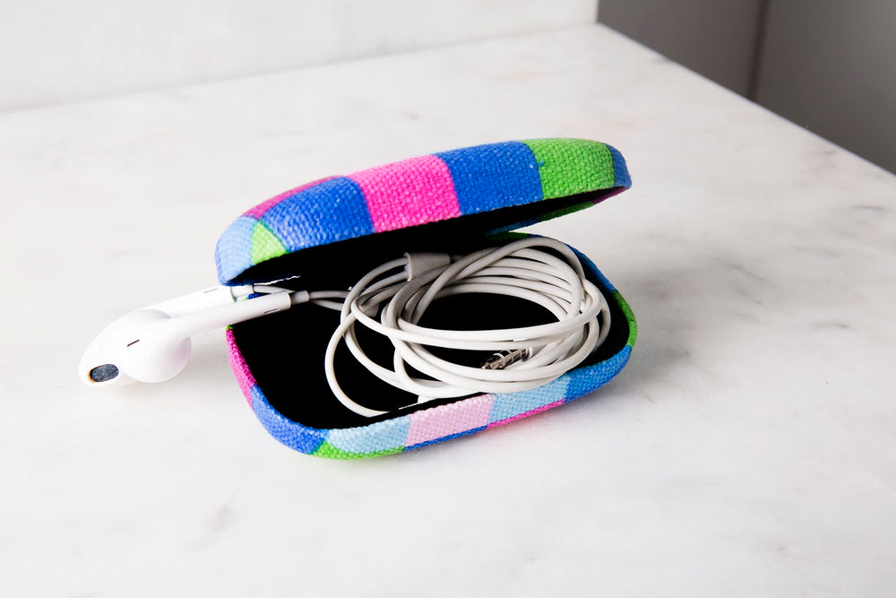 Kikkerland plaid organizer holds USB cables and chargers to prevent tangles.
