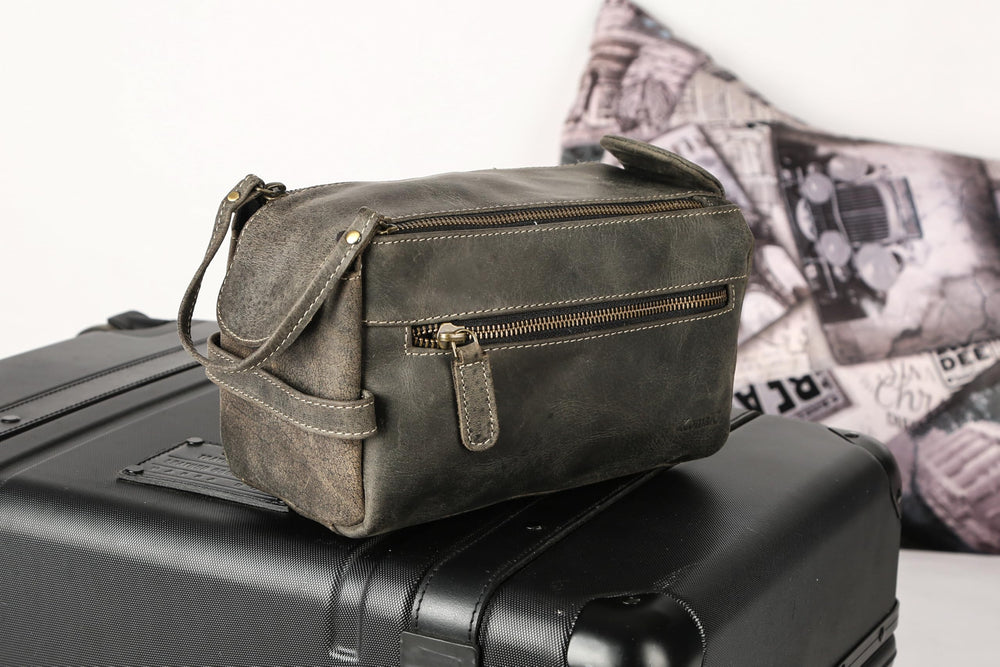KomalC charcoal-black toiletry bag styled for gifting and versatile use.