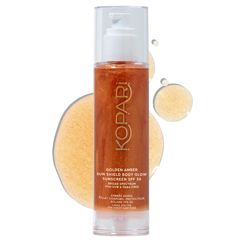 Kopari Sun Shield Body Glow bottle with golden shimmer for radiant protection.