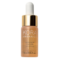 KORA Organics Noni Glow face oil bottle on vanity delivers antioxidant-rich hydration.