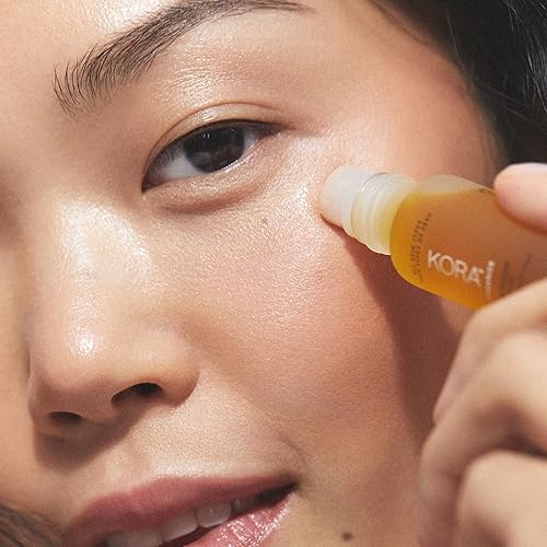 KORA Organics Noni Radiant Eye Oil Roller massage in action for soothing, depuffing application.