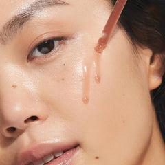 KORA Organics Turmeric Glow Drops dropper closeup highlights antioxidant-rich formula for even tone.
