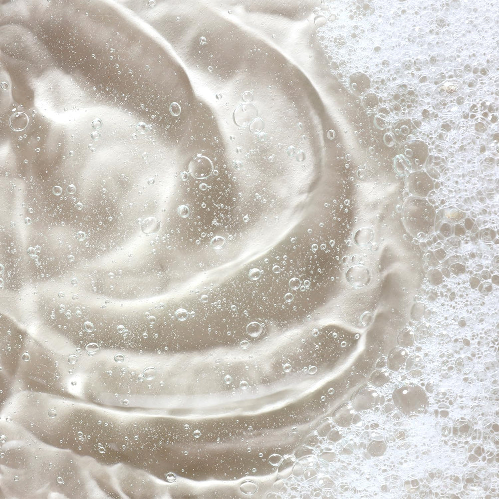 KORA Organics Turmeric Glow Foaming Cleanser at the sink ready for morning cleanse