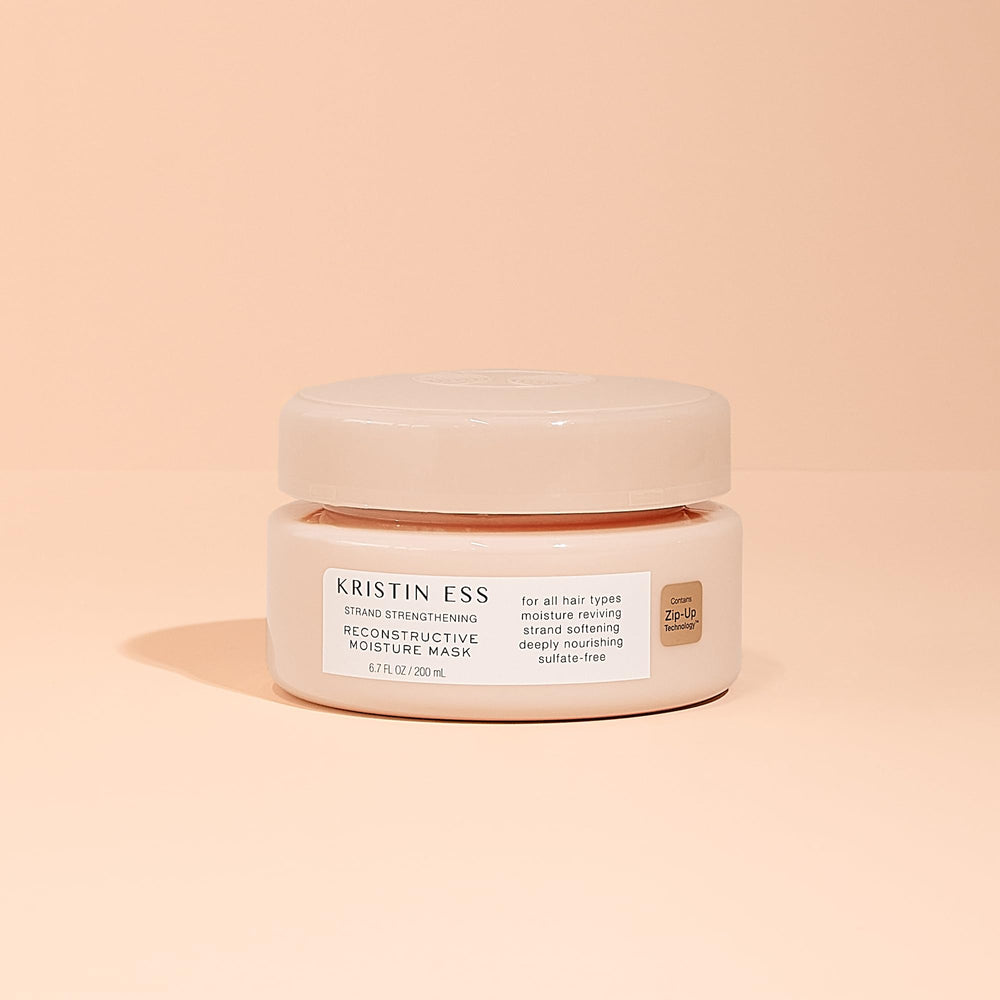 Kristin Ess packaging flatlay conveys product branding and premium conditioning.