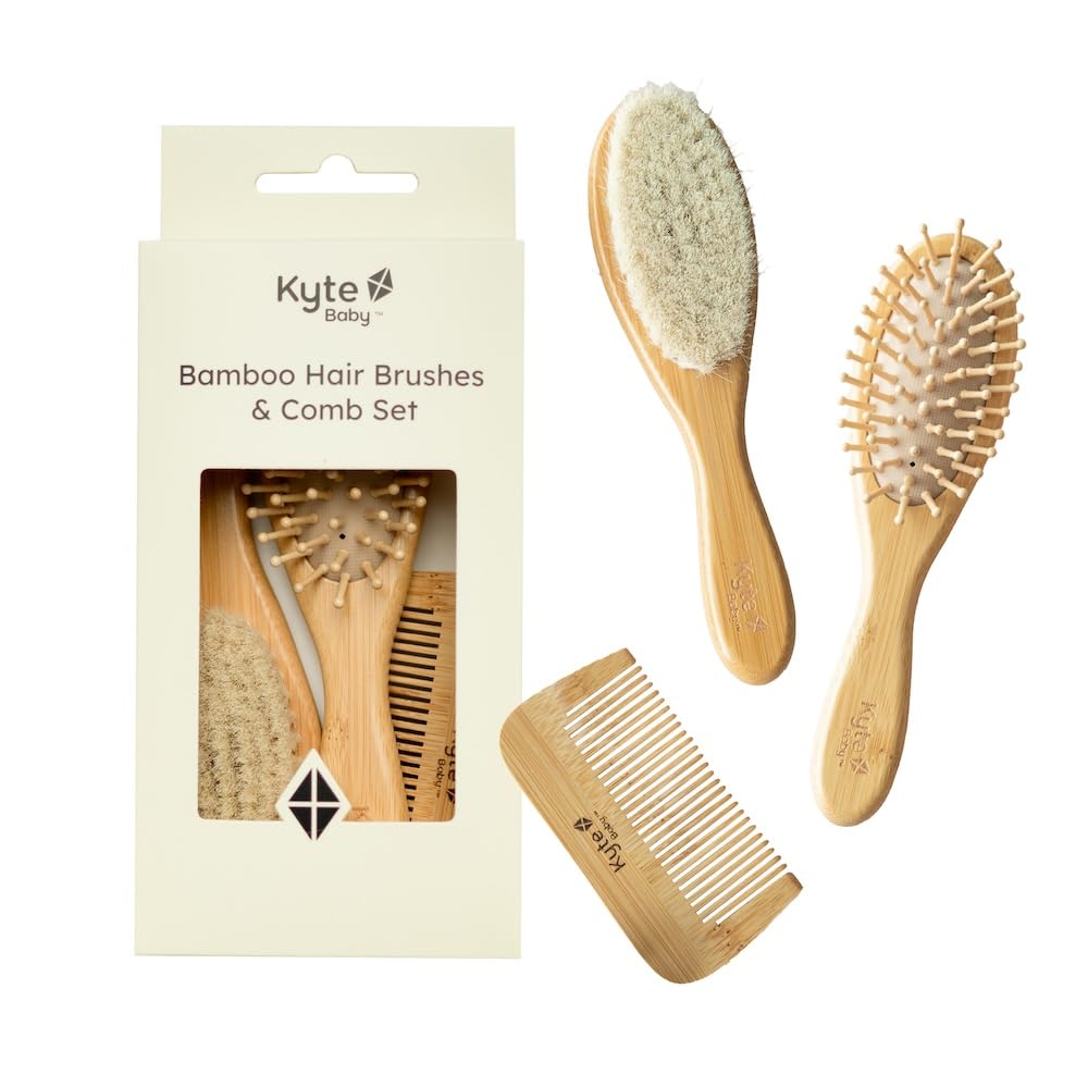 Kyte Baby bamboo 3-piece brush set goat hair brush close-up for gentle grooming.