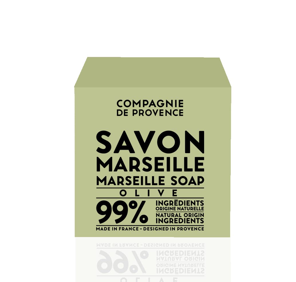 La Compagnie de Provence Savon Marseille Olive Soap Cube in-use hand for gentle cleansing.