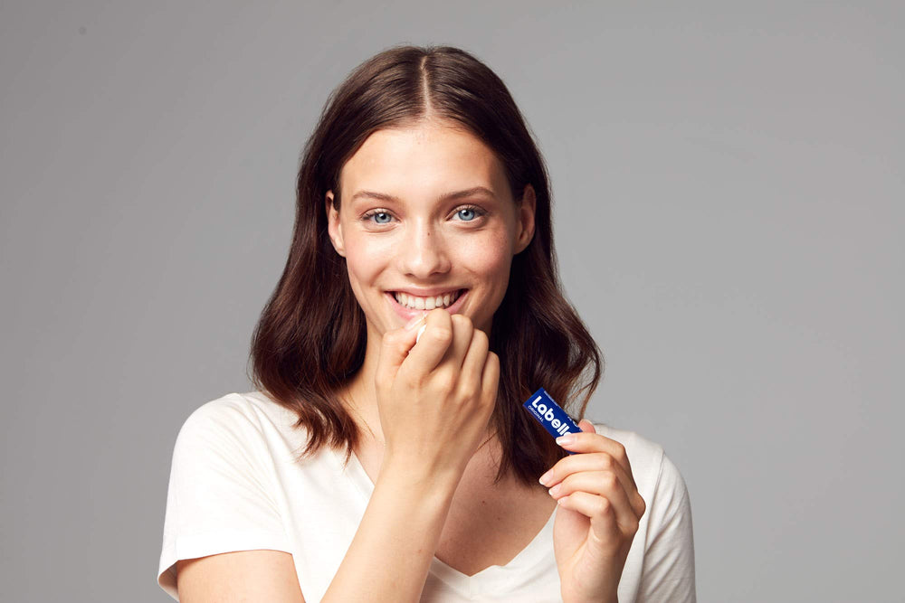 Labello Original Lip Balm being applied on lips for glide.