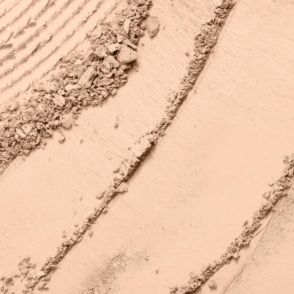 Lancôme Dual Finish Powder Foundation wet-application swatch demonstrates buildable coverage.