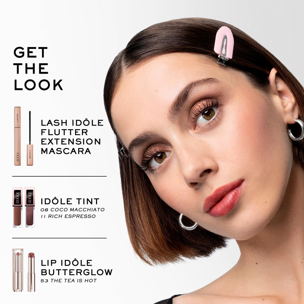 Lancôme Idôle Tint shimmer espresso liquid highlighter on cheekbone.