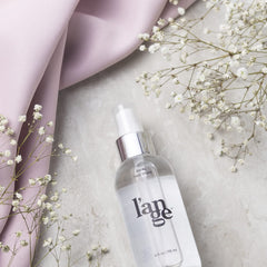 L'ANGE HAIR Rival Heat Shield being sprayed onto hair for smooth styling.