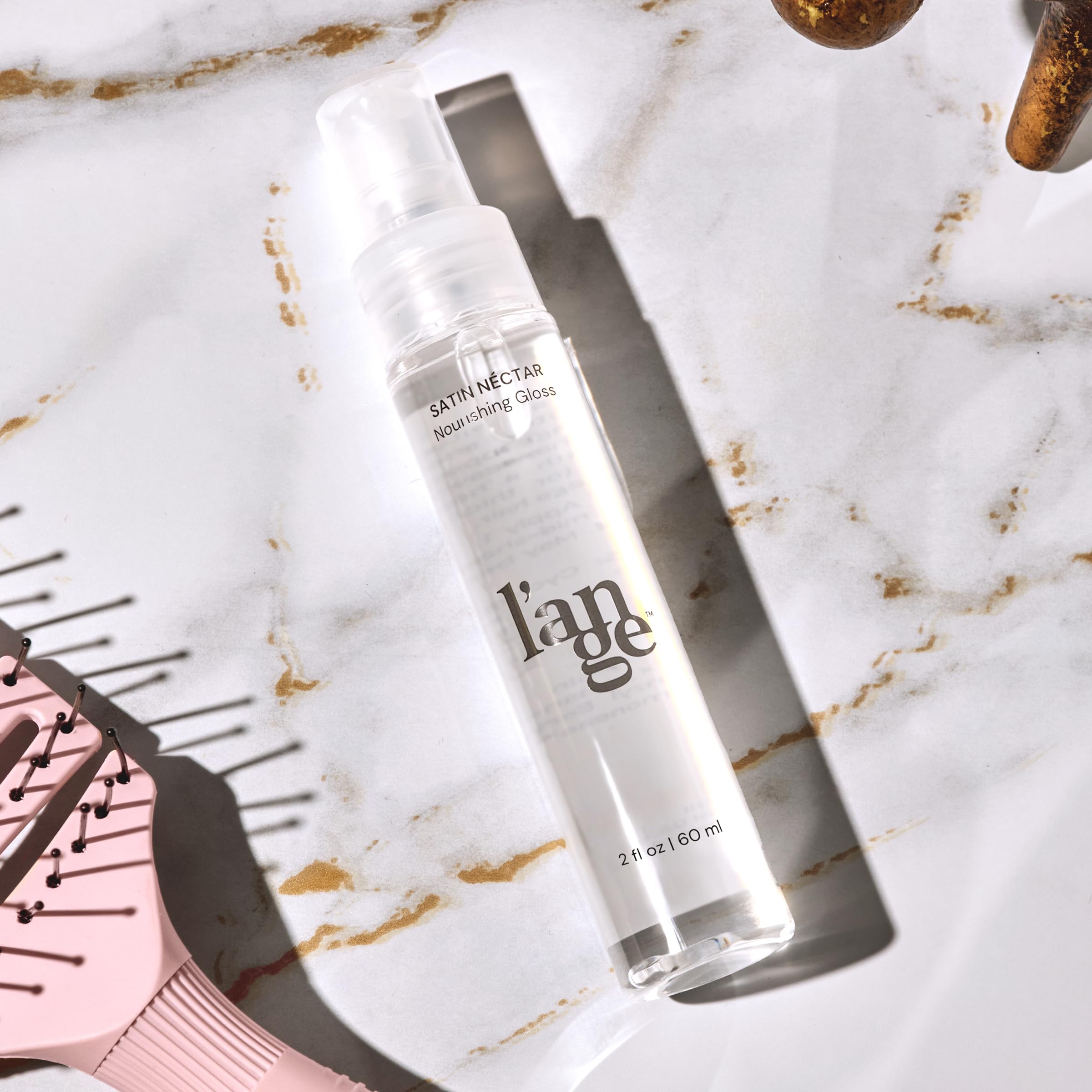 L'ANGE Satin Néctar gloss bottle packaging emphasizes travel-friendly size for on-the-go styling