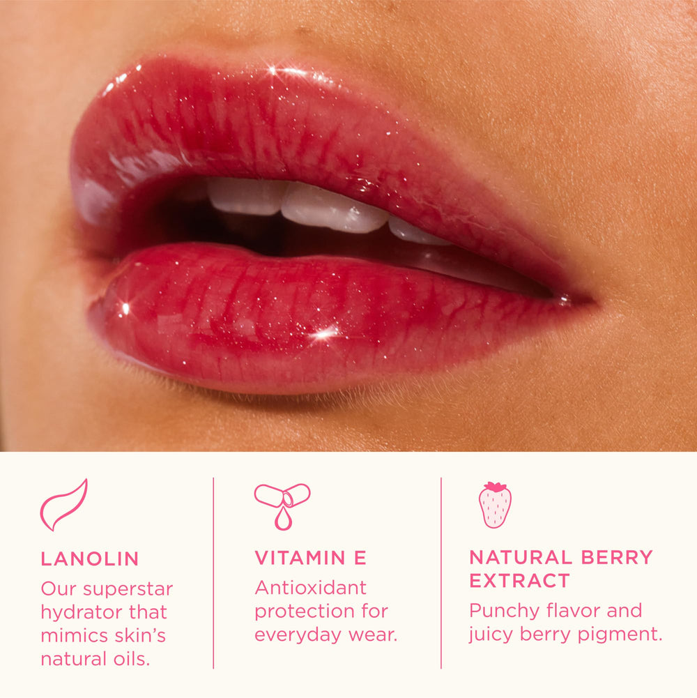 Lanolips Glossybalm Berry swirl gloss with light shimmer in hand.