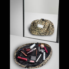Lay-n-Go Cosmo layflat bag rolled-closed demonstrates cinch to close convenience for mess-free travel.