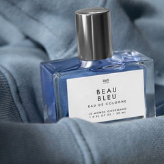 Violet leaves accent in Beau Bleu bottle for refined, airy elegance.