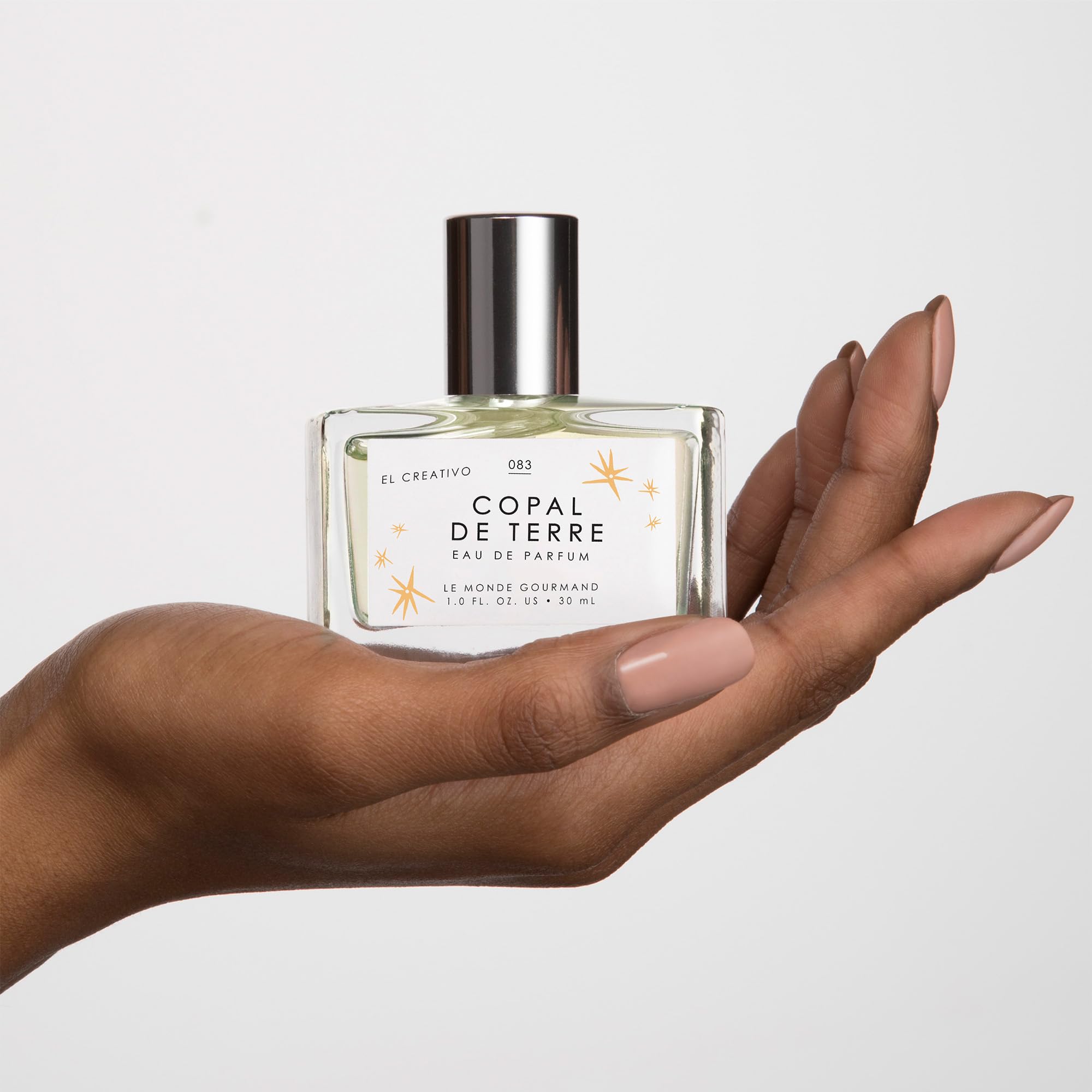 Le Monde Gourmand Copal de Terre glass bottle with amber tones conveys woody amber elegance.