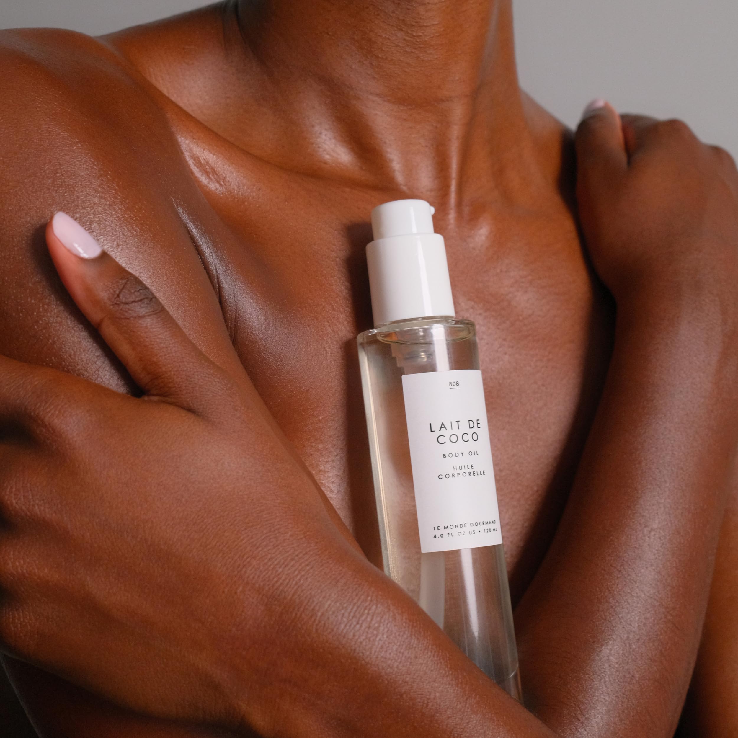Swirl of Le Monde Gourmand Lait de Coco Body Oil on skin for hydration glow.