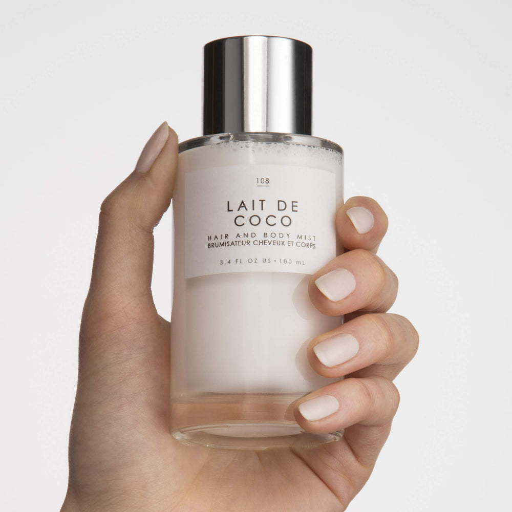 Le Monde Gourmand Lait de Coco mist on a hairbrush for subtle scent.