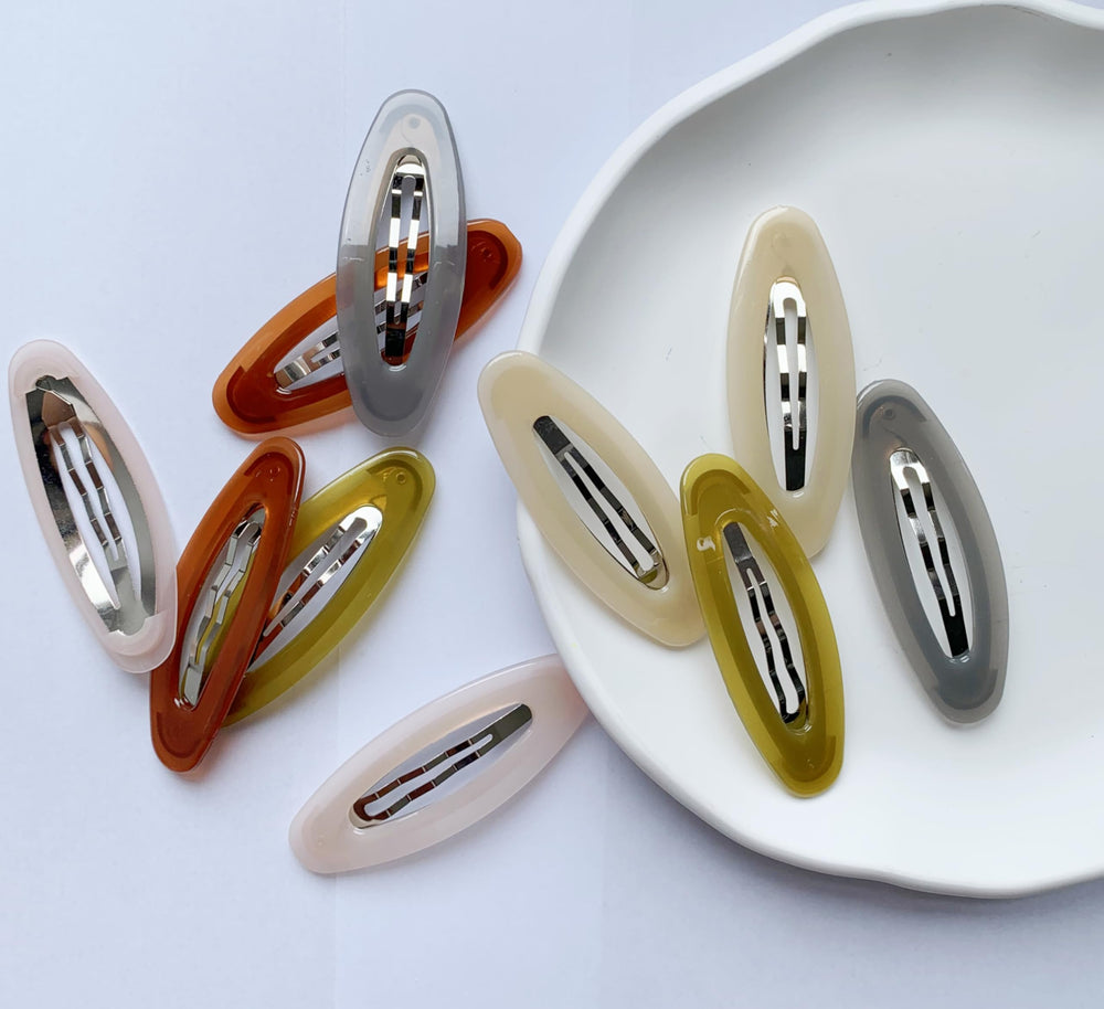 Lemeilleur pink resin oval clip adds cute accent with secure hold.