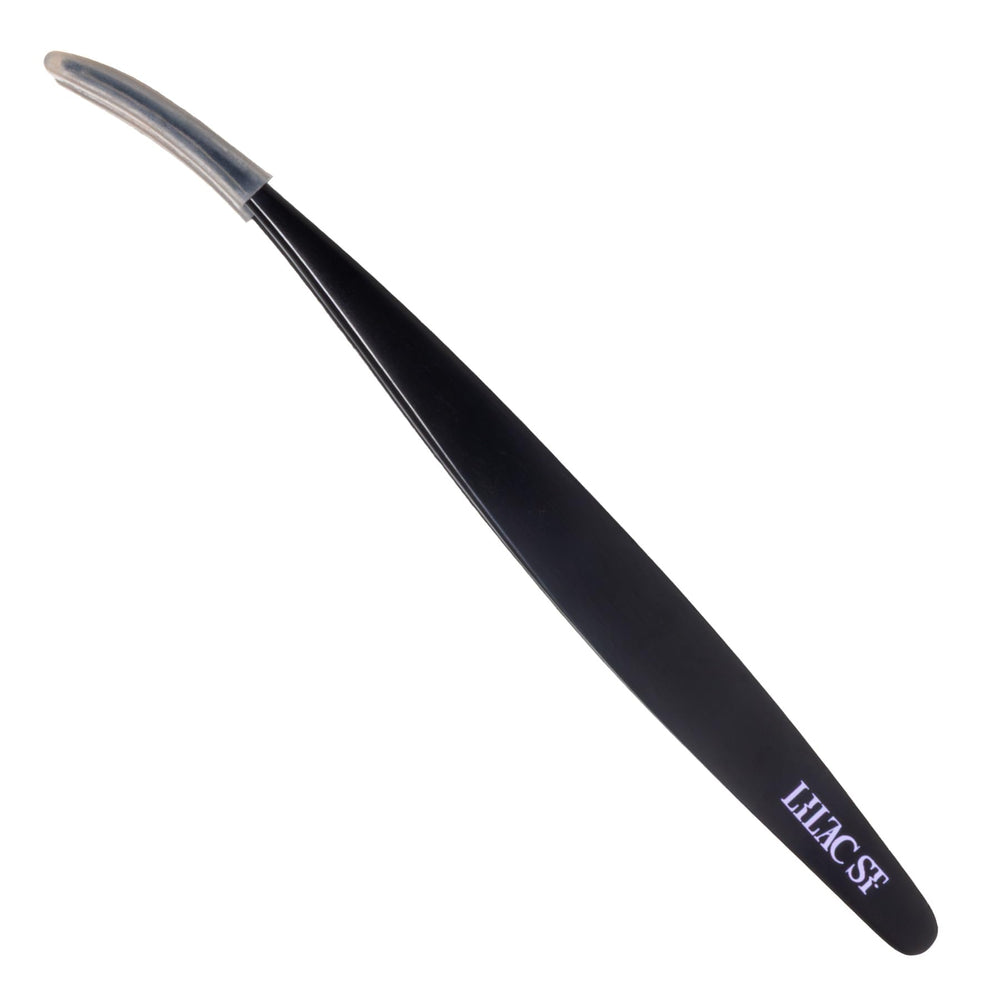 Lilac St. lash applicator with ergonomic curved end for precise lash placement.