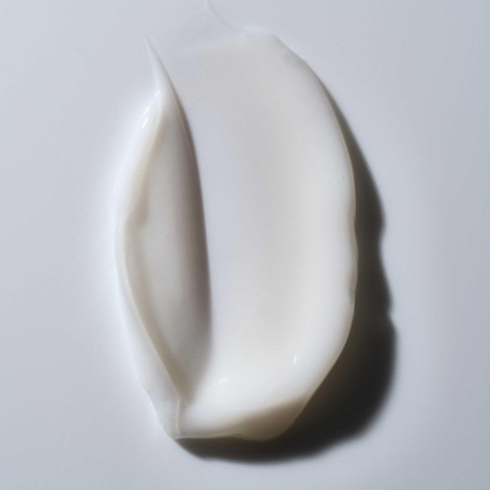Living Proof Curl Shampoo bottle with towel suggests a quick, hydrating curl-care routine