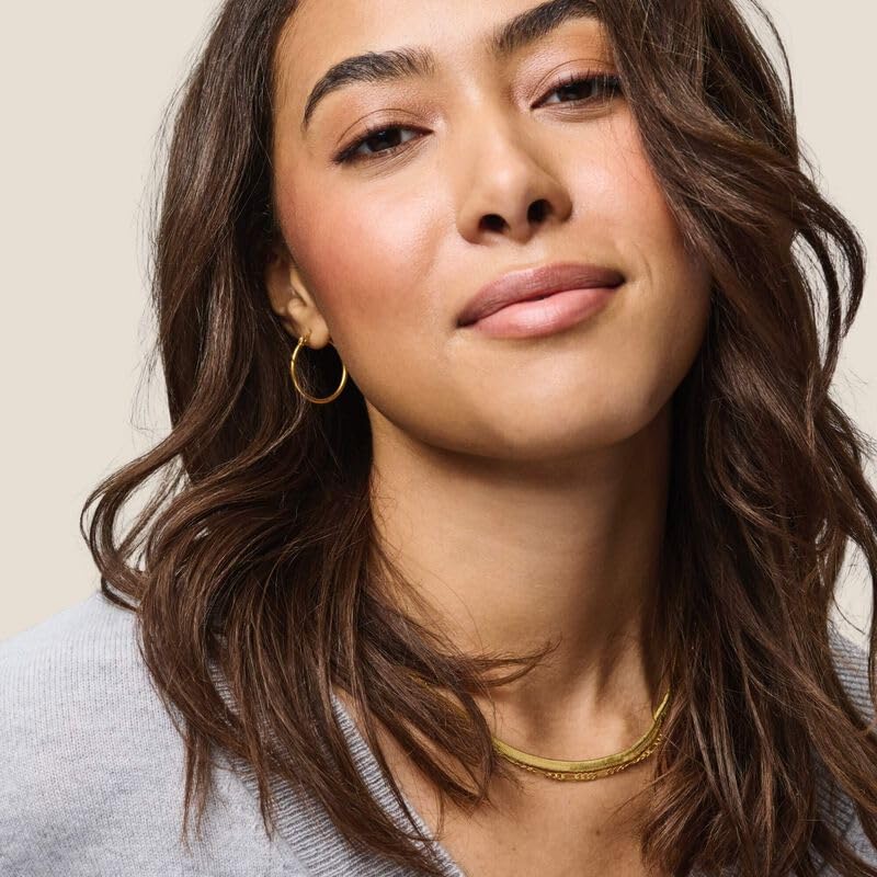 Living Proof No Frizz Instant De-Frizzer in-use during a busy morning routine.